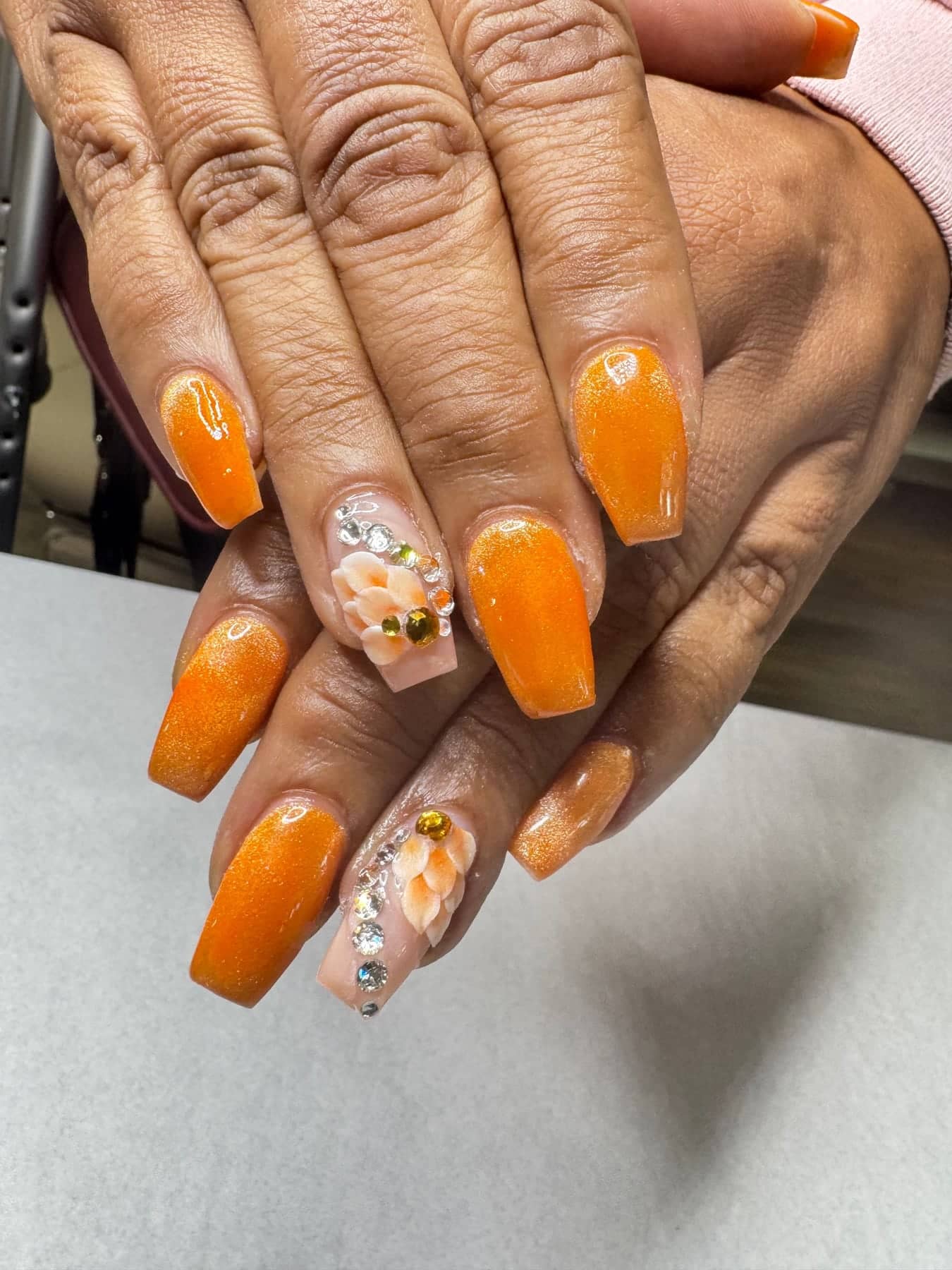 Orange nails with white flowers