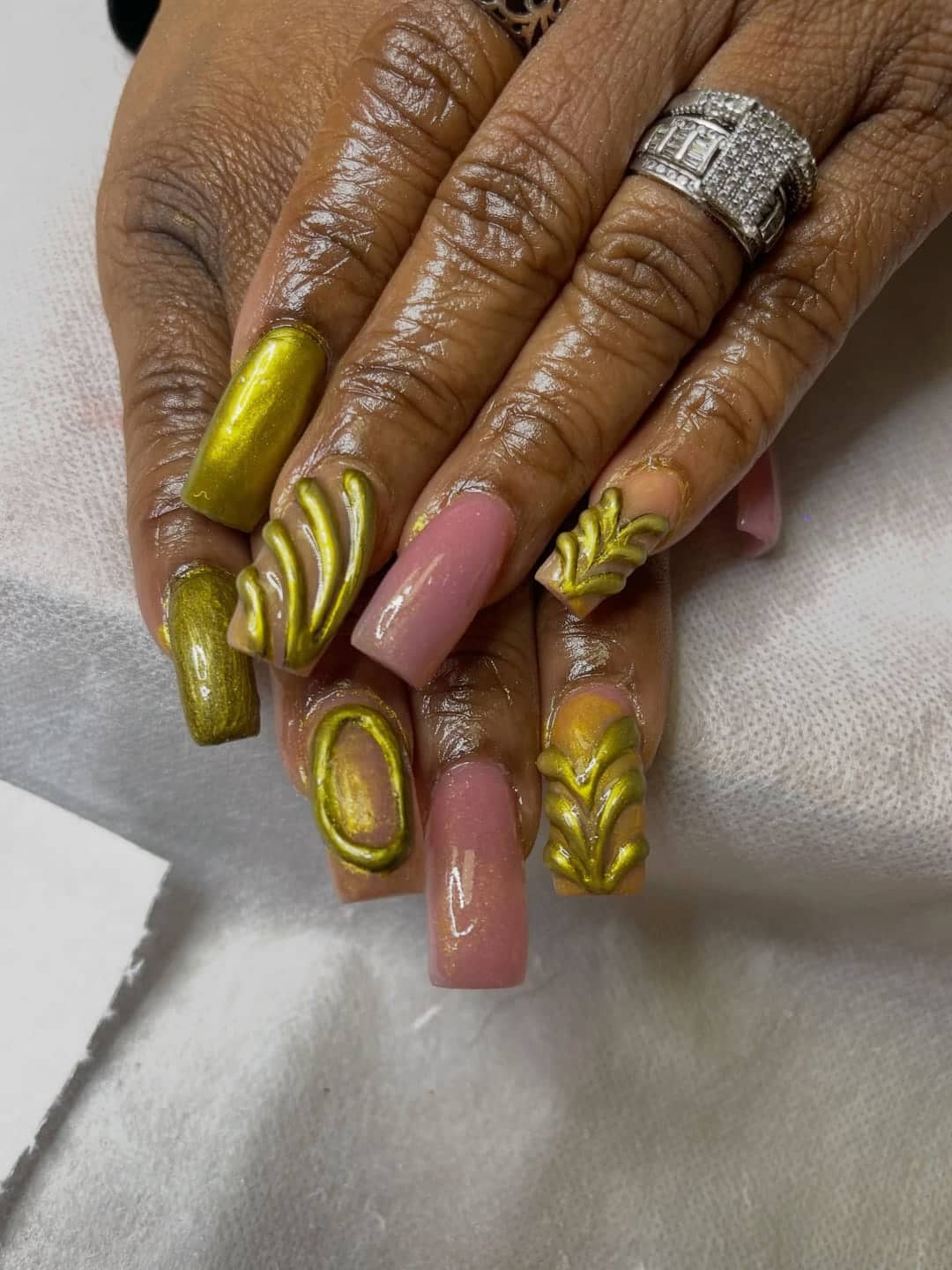 Gold chrome coffin nails with a bare accent