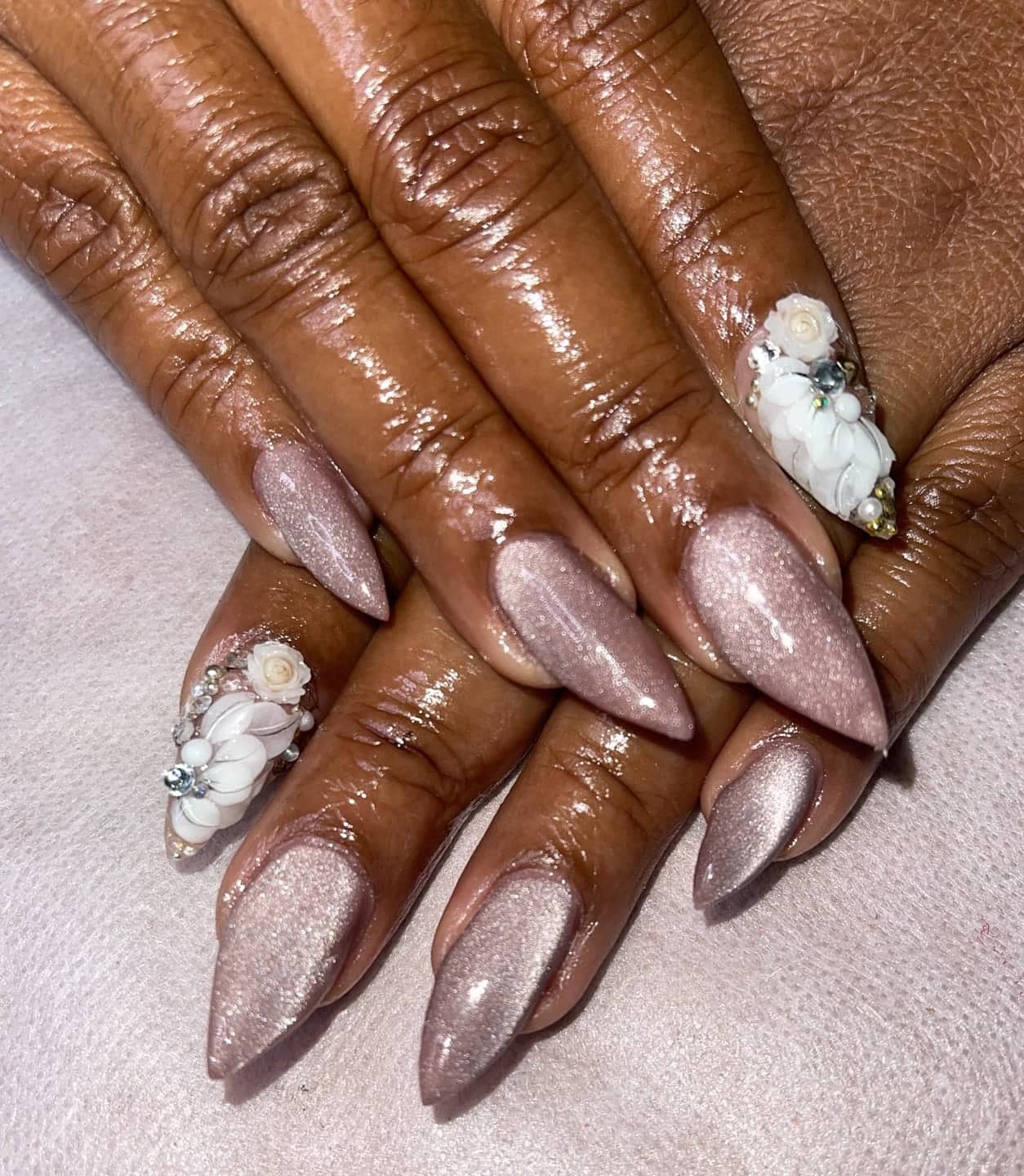 Chrome nails with sculpted white flowers