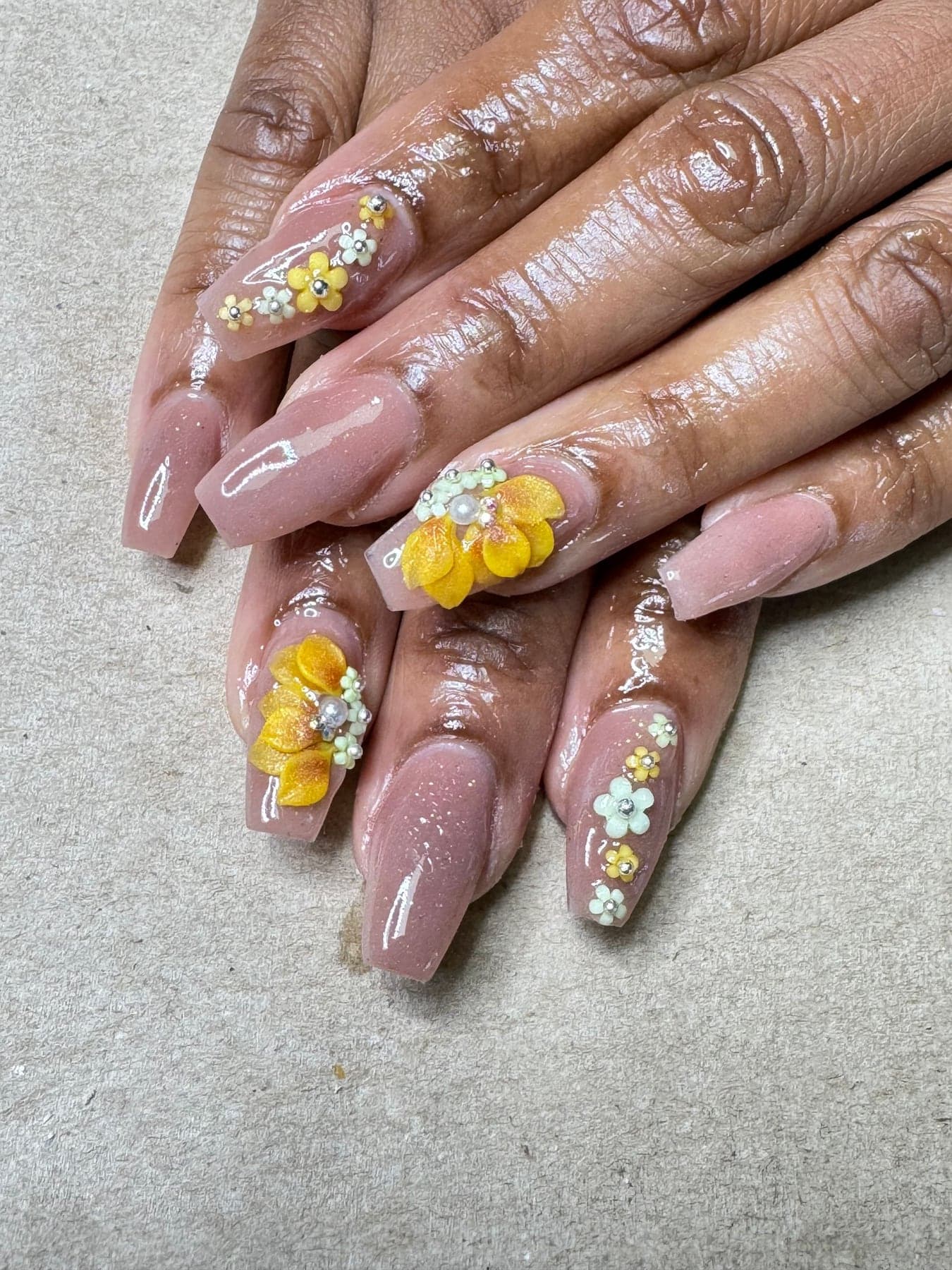 Pink nails with daisies and gold accents